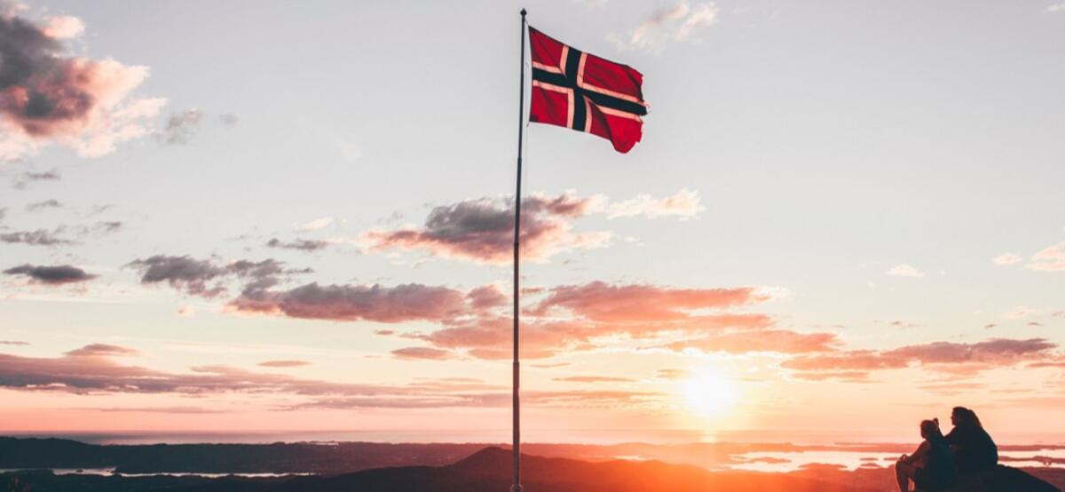 Foto af norsk flag og landskab